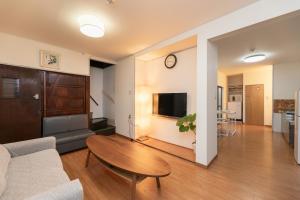 a living room with a couch and a table at Osaka Kanzakigawa Royal駅徒步1分 "private house 3 bed rooms "一棟貸し宿 in Osaka