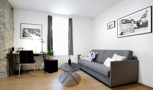 a living room with a couch and a table at Hotel Zugertor in Zug
