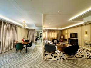 a living room with a couch and a table at The Nishat Hotel Johar Town in Lahore