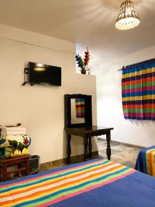 a bedroom with a bed and a table with a mirror at Hotel Yalnazac Mitla in San Pablo Villa de Mitla