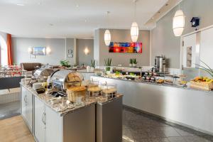 a buffet line in a restaurant with food on it at Garner Hotel Berlin - Checkpoint Charlie by IHG in Berlin