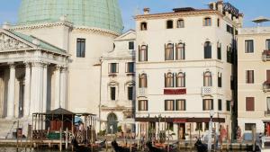 un grupo de edificios con góndolas en el agua en Hotel Antiche Figure, en Venecia