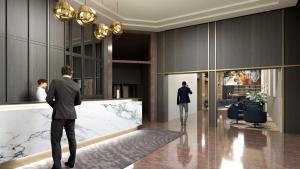 a man in a suit walking through a lobby at Palazzo President in Split
