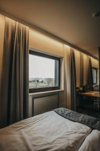 a bedroom with a bed and a window at Air Hotel in Warsaw