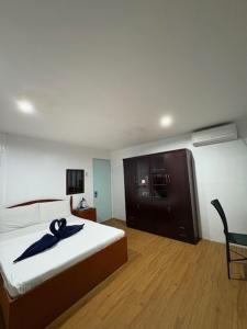 a bedroom with a bed with a blue ribbon on it at DUCK INN AND RESTAURANT in Manila
