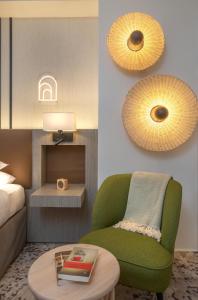 a living room with a green chair and a table at FirstName Toulouse by Hyatt in Toulouse