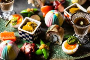 a plate of food with eggs and vegetables on a table at Atarayo Nishiizu Onsen in Izu