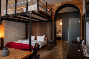 a bedroom with a bunk bed with a red bedspread at Hotel Adele am Alex in Berlin