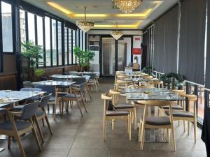 a row of tables and chairs in a restaurant at The Sterling Boutique Hotel Melaka in Malacca