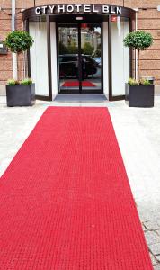 a red carpet in front of a building at BlnCty Hotel in Berlin