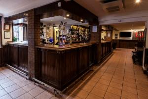 a bar in a pub with a wooden counter at The Arch Inn in Ullapool