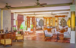 a lobby with chairs and tables in a room at Anantara Angkor Resort in Siem Reap