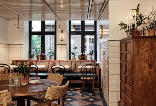 a restaurant with tables and chairs and windows at Hotel Sanders in Copenhagen