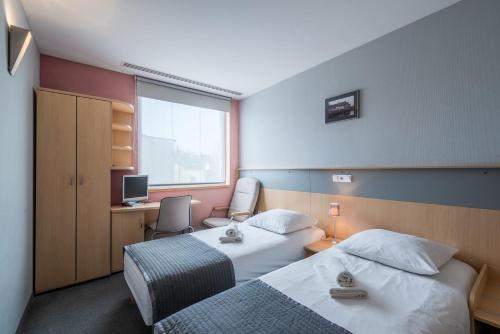 Vuode tai vuoteita majoituspaikassa Weiser Hotel