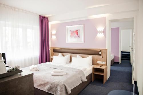a bedroom with a bed with two towels on it at Hotel Nikolai Residence in Berlin