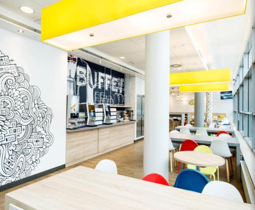a dining area with tables and chairs in a restaurant at ibis budget Warszawa Centrum in Warsaw