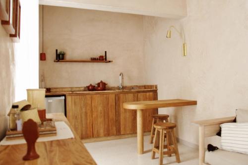 a kitchen with a wooden table and a counter at Casa Antonieta in Oaxaca City