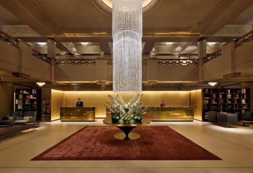 a lobby with a table in the middle of a room at Hotel Cafe Royal in London