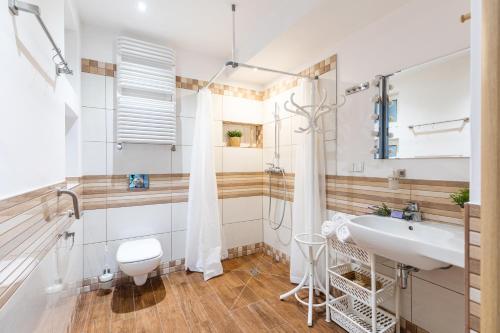 a bathroom with a sink and a shower at SuperApart Cieplarniana 44B in Warszawa