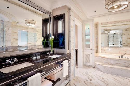 a bathroom with two sinks and a large mirror at The Ritz-Carlton, Berlin in Berlin