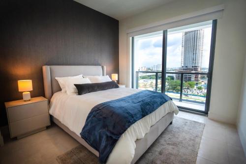 ein Schlafzimmer mit großem Bett und großem Fenster in der Unterkunft Smart Brickell Hotel in Miami