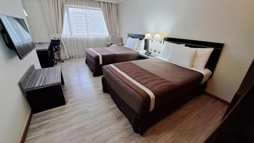 Giường trong phòng chung tại Hotel Diego de Almagro Providencia