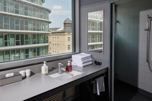 a bathroom with a sink and a window at Casa Camper Berlin in Berlin