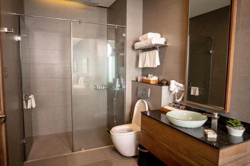a bathroom with a shower and a toilet and a sink at Escala Tagaytay in Tagaytay