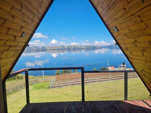a view of a lake from a porch at Cabañas el Olimpo in Aquitania