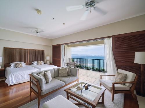 a hotel room with a bed and a large window at The Terrace Club Wellness Thalasso At Busena in Nago