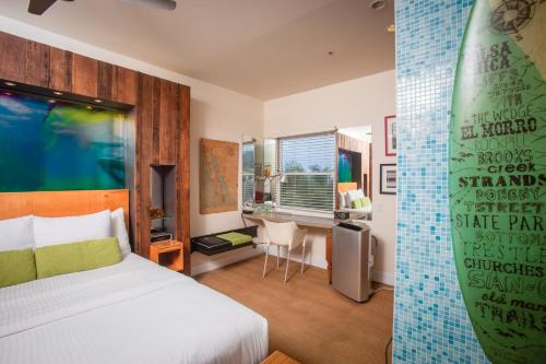a bedroom with a bed and a surfboard on the wall at La Casa Del Camino in Laguna Beach